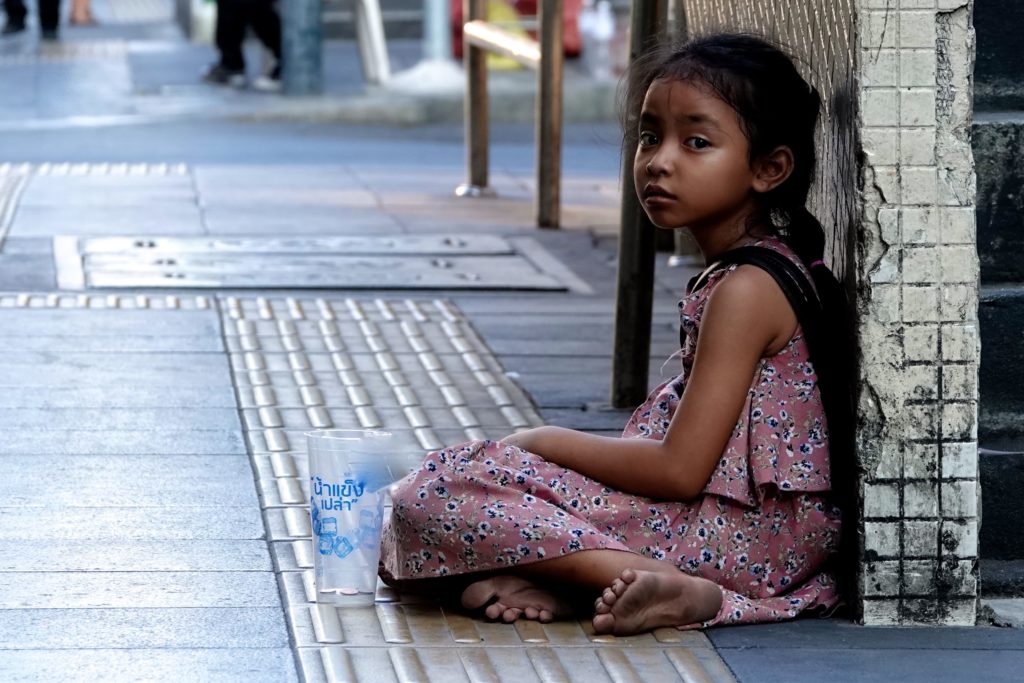 Bettelndes Mädchen auf der Straße in Bangkok.