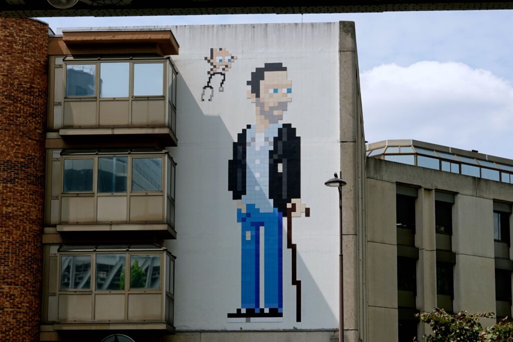 Pixelkunst-Wandbild "Dr. House" von Invader an der Fassade des Krankenhauses Pitié-Salpêtrière im 13. Arrondissement Paris